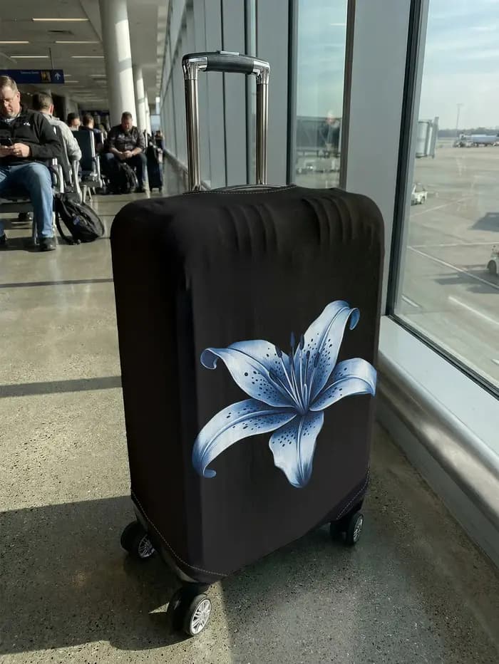 Housse de bagage à motif de fleurs de lys bleues sur base noire